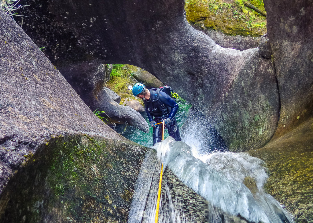 Leigh starting down the tube rappel